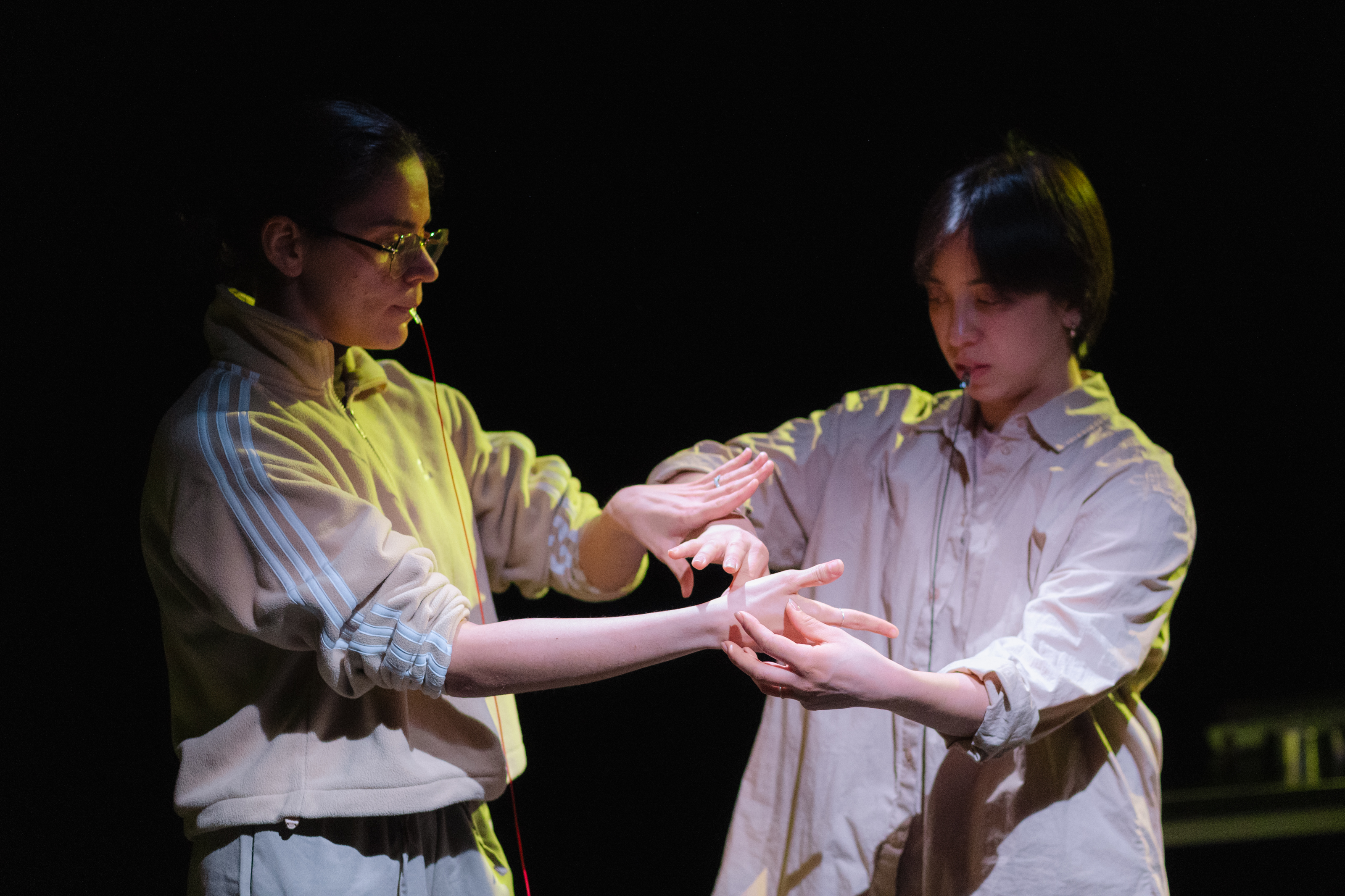 Two dancers touching one another.